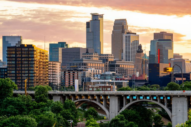 10th Avenue Bridge and Minneapolis Skyline at sunset 1 Minneapolis downtown skyline at sunset with the 10th Avenue Bridge crossing the Mississippi River in foreground.