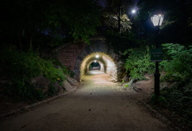 The Inscope Arch sits near the southeast corner of Central Park, close to Grand Army Plaza and 59th Street. At night, the stone passageway offers a calm, almost hidden route beneath the park’s trees.