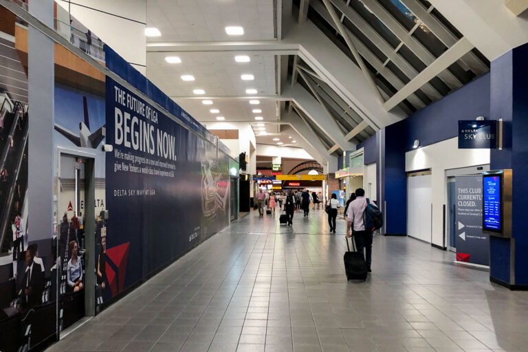 LaGuardia Airport Construction 2 Travelers walk past a construction wall at LaGuardia Airport in Queens, New York, on Sunday, Sept. 14, 2025. Renovations continue at the Delta terminal as part of the airport’s multibillion-dollar redevelopment project.