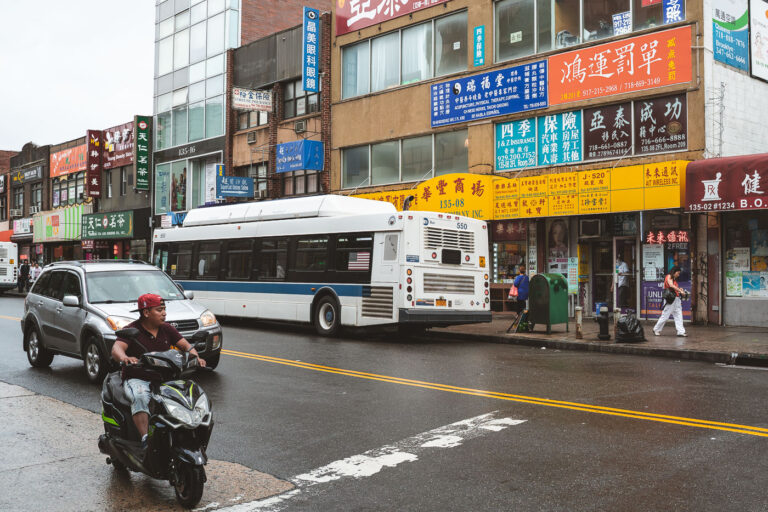 Roosevelt Flushing, New York City 1 An MTA bus is stopped along Roosevelt Avenue in Flushing, Queens, a bustling corridor lined with Chinese and Korean storefronts.