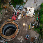 The shaft being made that will bring a tunnel boring machine to bore a tunnel under the Mississippi River for a water main.