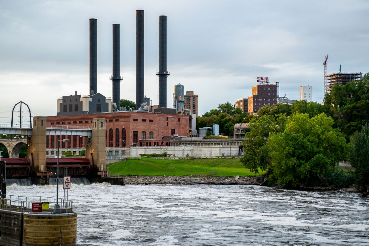 The Southeast Steam Plant, with its four iconic smokestacks, rises over the Mississippi River near the University of Minnesota’s East Bank campus. Once a coal-fired power station, the facility has been adapted into a cleaner-burning natural gas plant, continuing its role as a landmark in Minneapolis’s industrial skyline.