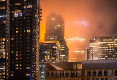 A foggy night in downtown Minneapolis with IDS Center in the background with Xcel Energy Headquarters in the foreground.
