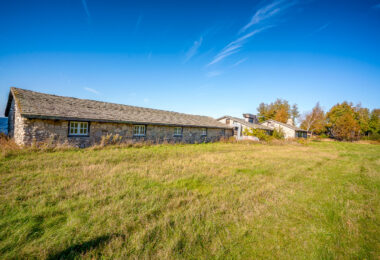Built in the early 1930s, Chateau Hutter was originally envisioned as a European-style resort and winery overlooking Sturgeon Bay in Door County, Wisconsin. The stone building, designed with locally quarried limestone and heavy timber framing, has long been abandoned but still stands as a striking relic of pre-war leisure architecture. Its location on a bluff above Lake Michigan and its craftsmanship make it one of the region’s most enigmatic remnants of early tourism development.