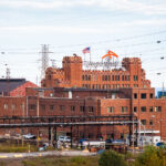 The ArcelorMittal Indiana Harbor steel mill in East Chicago, Indiana, is one of the largest integrated steelmaking facilities in the United States. The complex traces its origins to the Inland Steel Company, founded in 1893, and its massive brick headquarters—seen here—was built in the early 20th century to symbolize industrial power along Lake Michigan. Today, the plant remains a cornerstone of American steel production, encompassing multiple blast furnaces, coke batteries, and finishing lines. Now operated by Cleveland-Cliffs following its 2020 acquisition of ArcelorMittal USA, Indiana Harbor continues more than a century of continuous steelmaking on Chicago’s industrial lakeshore.