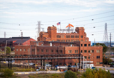 The ArcelorMittal Indiana Harbor steel mill in East Chicago, Indiana, is one of the largest integrated steelmaking facilities in the United States. The complex traces its origins to the Inland Steel Company, founded in 1893, and its massive brick headquarters—seen here—was built in the early 20th century to symbolize industrial power along Lake Michigan. Today, the plant remains a cornerstone of American steel production, encompassing multiple blast furnaces, coke batteries, and finishing lines. Now operated by Cleveland-Cliffs following its 2020 acquisition of ArcelorMittal USA, Indiana Harbor continues more than a century of continuous steelmaking on Chicago’s industrial lakeshore.