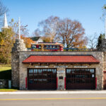 The historic Ephraim Volunteer Fire Department Museum, housed in a stone building with classic red doors, stands as a reminder of small-town service and heritage in Ephraim, Wisconsin.
