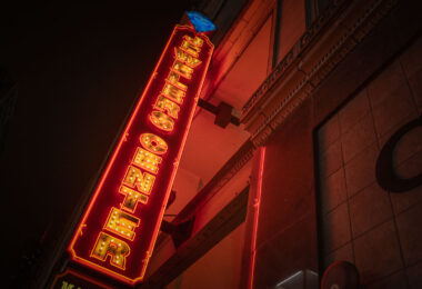 The illuminated marquee of the Jewelers Center glows along South Wabash Avenue in Chicago’s historic Jewelers Row District. Located at 5 S Wabash, this 1920s-era Art Deco building is home to more than 180 independent jewelers and gem traders, many specializing in custom design and repair. The tower, part of the landmark Mallers Building, stands within the Loop’s long tradition of craftsmanship and trade that dates back to the city’s early commercial boom. At night, the neon-lit sign continues to evoke Chicago’s mid-century downtown energy, linking the modern financial core with its industrial and artisanal past.