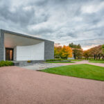 The Lakewood Cemetery Garden Mausoleum, completed in 2012 and designed by Joan Soranno and John Cook of HGA Architects, represents a modern counterpart to Lakewood’s historic chapel. Built into the natural slope of the cemetery grounds, the structure uses gray granite and white mosaic marble to evoke quiet reflection and permanence. Its minimalist form and interplay of light were conceived to harmonize with the surrounding landscape of Lake Calhoun (Bde Maka Ska). The mausoleum extends Lakewood’s 150-year tradition of blending architecture, art, and remembrance within a park-like setting in south Minneapolis.
