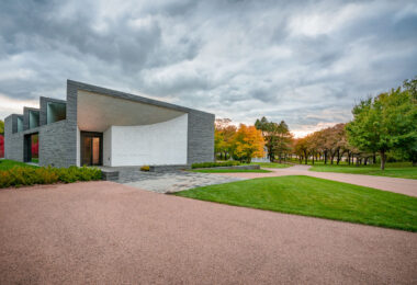 The Lakewood Cemetery Garden Mausoleum, completed in 2012 and designed by Joan Soranno and John Cook of HGA Architects, represents a modern counterpart to Lakewood’s historic chapel. Built into the natural slope of the cemetery grounds, the structure uses gray granite and white mosaic marble to evoke quiet reflection and permanence. Its minimalist form and interplay of light were conceived to harmonize with the surrounding landscape of Lake Calhoun (Bde Maka Ska). The mausoleum extends Lakewood’s 150-year tradition of blending architecture, art, and remembrance within a park-like setting in south Minneapolis.