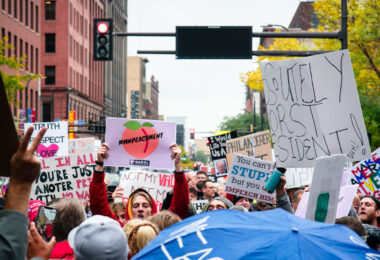 Protesters crowd Nicollet Mall in downtown Minneapolis carrying handmade signs during a demonstration against then-President Donald Trump on October 10, 2019. The rally, tagged online as #MNPEACHMENT, drew thousands of Minnesotans expressing opposition to Trump’s policies and calling for impeachment. The march began near the Target Center, where Trump was holding a campaign rally, and stretched across downtown under a heavy police presence.