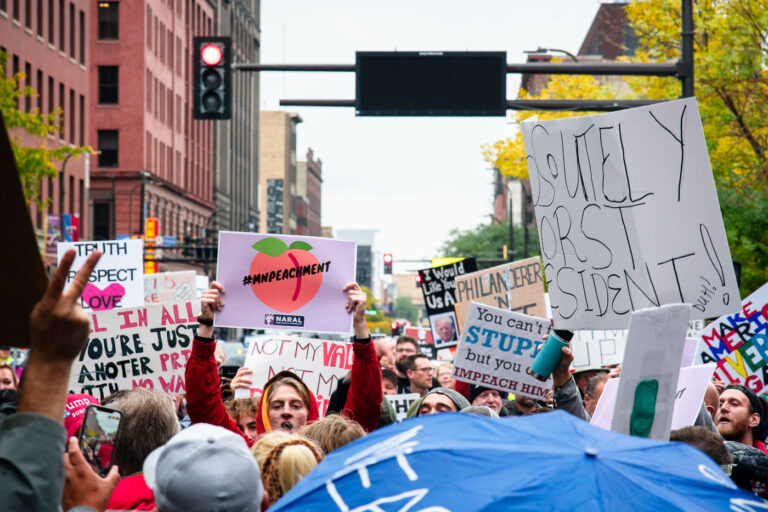 MNPEACHMENT March on Nicollet Mall, Downtown Minneapolis 4 Protesters crowd Nicollet Mall in downtown Minneapolis carrying handmade signs during a demonstration against then-President Donald Trump on October 10, 2019. The rally, tagged online as #MNPEACHMENT, drew thousands of Minnesotans expressing opposition to Trump’s policies and calling for impeachment. The march began near the Target Center, where Trump was holding a campaign rally, and stretched across downtown under a heavy police presence.
