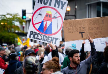 Protesers hold up signs outside the Target Center in Minneapolis on October 10, 2019.