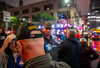 During demonstrations outside President Donald Trump’s campaign rally at the Target Center in downtown Minneapolis on October 10, 2019, a man wearing a hat bearing the Oath Keepers insignia asked for directions near the crowd. The rally drew both Trump supporters and counter-protesters, filling Hennepin Avenue with thousands of people and heavy police presence. The Oath Keepers, founded in 2009, is a far-right, anti-government militia organization whose members have been linked to armed protests and later to the January 6, 2021, U.S. Capitol attack.