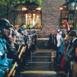 Minneapolis police officers in riot gear form a barricade opposite protesters outside the Target Center on October 10, 2019, during then-President Donald Trump’s campaign rally. The tightly organized police line extended along First Avenue, separating demonstrators from event attendees as tensions rose late into the evening. The rally drew thousands of protesters and supporters to downtown Minneapolis, prompting one of the largest coordinated law enforcement deployments in the city that year.