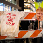 A barricade outside the Target Center in downtown Minneapolis displays a T-shirt reading “Russia Made Me Do It” and a defaced cutout of Donald Trump’s face during protests on October 10, 2019. The demonstration coincided with Trump’s campaign rally at the arena, his first visit to Minnesota since the release of the Mueller report. Thousands of protesters gathered in the streets of the Warehouse District, voicing opposition to the president’s rhetoric and policies amid a heavy police presence and national media attention.