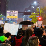 Protesters Gather Outside Trump Rally in Downtown Minneapolis, 2 2 Protesters fill the intersection near the Target Center in downtown Minneapolis during Donald Trump’s campaign rally on October 10, 2019. Demonstrators carried homemade signs, including one reading “This is Purple Rain Country—Take Your Golden Showers Back to Russia,” referencing Minnesota’s musical icon Prince and the controversies surrounding Trump’s presidency. The rally drew thousands of protesters and supporters alike, marking one of the city’s largest political demonstrations since the 2016 election.