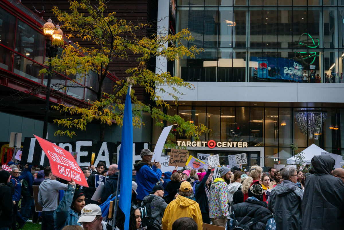 Protesters outside the Target Center in downtown Minneapolis. Trump supporters behind the glass. Campaign event October 10, 2019