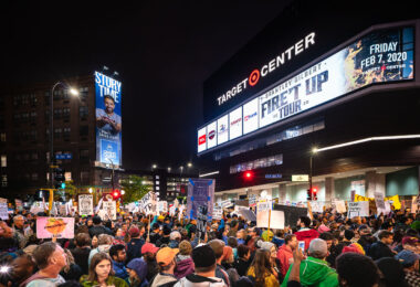 Protesters hold up signs outside the Target Center in downtown Minneapolis. The site of a Trump campaign rally on October 10, 2019.
