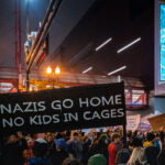 Crowds gathered outside the Target Center in downtown Minneapolis on October 10, 2019, during a Donald Trump campaign rally. Protesters held signs denouncing the administration’s immigration policies and far-right extremism, including one reading “Nazis Go Home – No Kids in Cages.” The event drew thousands of demonstrators and marked one of the city’s largest public displays of opposition during Trump’s presidency.