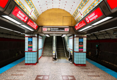 Randolph/Washington station sits beneath the heart of downtown Chicago, forming part of the CTA Red Line that runs through the State Street subway. Opened in 1943 as part of the city’s ambitious subway expansion, the station connects directly to the extensive Chicago Pedway system, linking offices, retail centers, and civic buildings underground. Its tiled vault and distinctive 1940s-era design remain largely intact, representing the Art Moderne phase of Chicago’s transit infrastructure.
