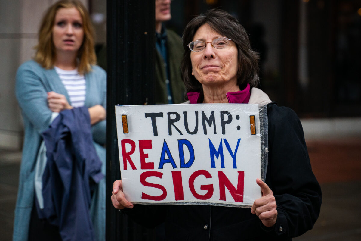 Minneapolis Trump Rally Protestor Holds Sign