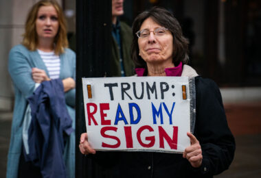 Woman holds up a sign that reads "Trump read my sign" in Minneapolis on October 10, 2019.