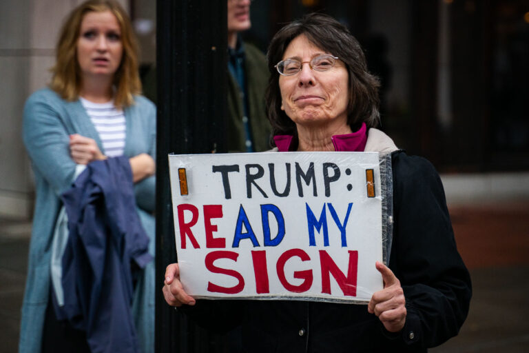 Read my sign, Minneapolis Trump Rally 4 Woman holds up a sign that reads "Trump read my sign" in Minneapolis on October 10, 2019.