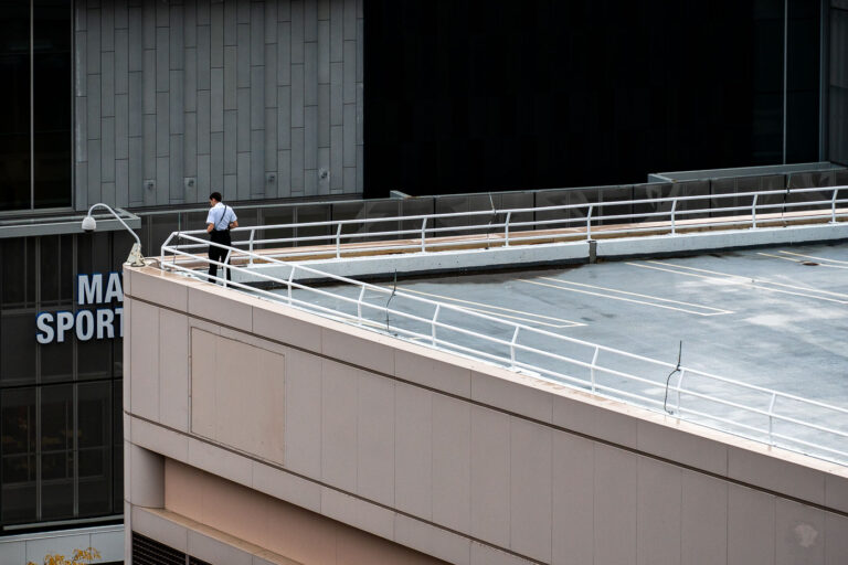 Security Detail on Rooftop Overlooking Target Center 4 A security officer surveys the area from a parking ramp rooftop across from the Target Center in downtown Minneapolis on October 10, 2019. The elevated position provided an unobstructed view of streets surrounding the arena ahead of a campaign rally held by President Donald Trump. Local police, federal agents, and Homeland Security personnel maintained a visible presence throughout the entertainment district as thousands of attendees and protesters gathered nearby.