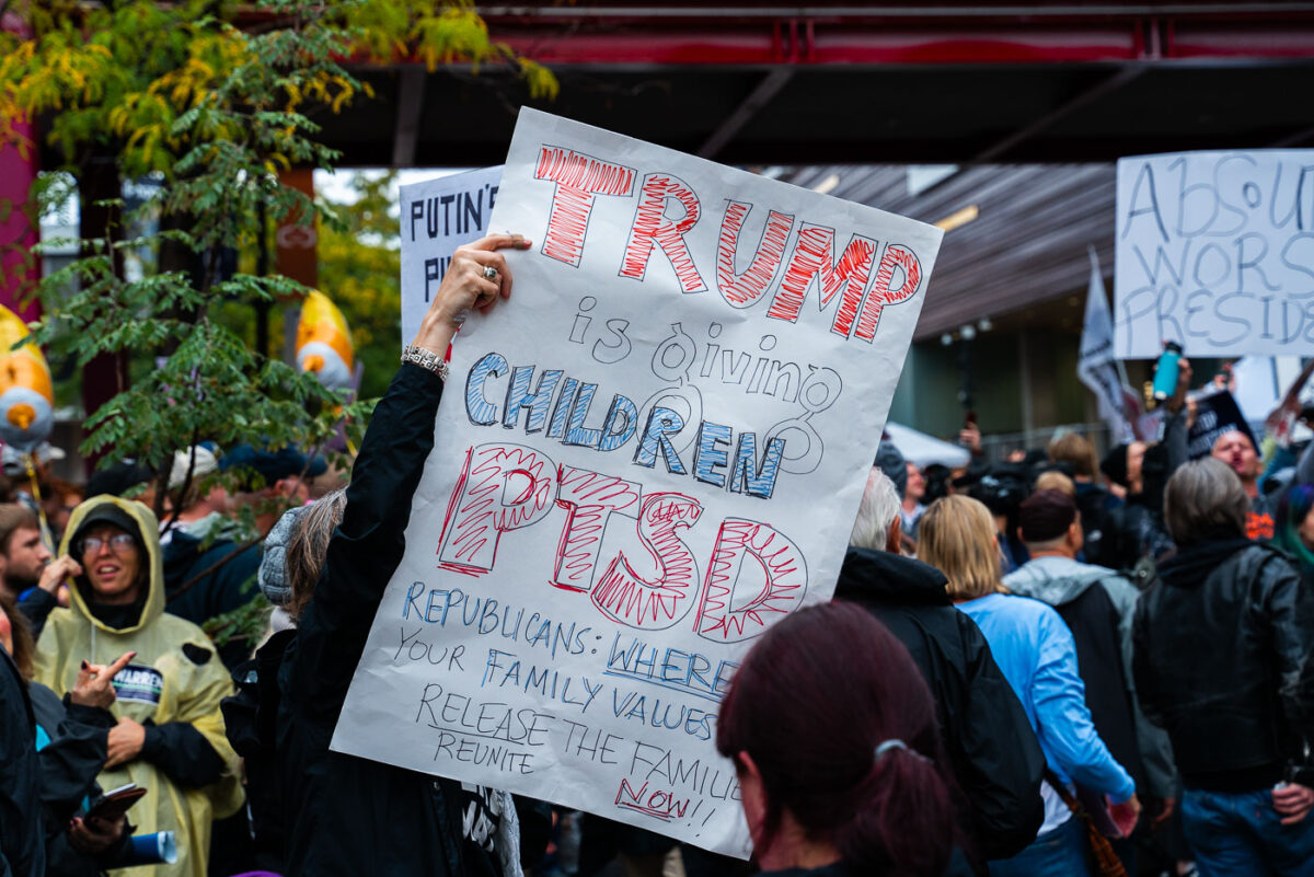 A protester holds up protest sign outside the Target Center in Downtown Minneapolis where Trump was to speak in October 2019.