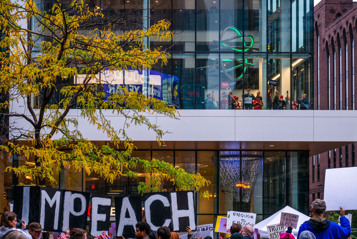 Protesters outside the Target Center in downtown Minneapolis. Trump supporters behind the glass. Campaign event October 10, 2019