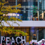 Protesters outside the Target Center in downtown Minneapolis. Trump supporters behind the glass. Campaign event October 10, 2019