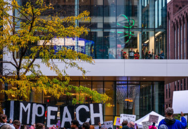 Protesters outside the Target Center in downtown Minneapolis. Trump supporters behind the glass. Campaign event October 10, 2019