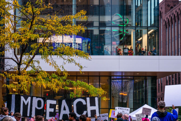 Trump protesters in 2019 in Minneapolis 2 Protesters outside the Target Center in downtown Minneapolis. Trump supporters behind the glass. Campaign event October 10, 2019