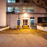 This view shows the rear loading and office entrance of the former General Mills Purity Oats facility in Northeast Minneapolis. Built during the city’s industrial boom, the complex once handled oat processing and packaging for one of the nation’s largest cereal producers. The structure’s painted brick walls, grain silos, and utilitarian layout are characteristic of mid-20th-century food-processing plants that supported the city’s reputation as the “Flour Milling Capital of the World.”