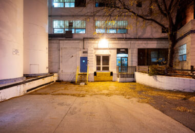 This view shows the rear loading and office entrance of the former General Mills Purity Oats facility in Northeast Minneapolis. Built during the city’s industrial boom, the complex once handled oat processing and packaging for one of the nation’s largest cereal producers. The structure’s painted brick walls, grain silos, and utilitarian layout are characteristic of mid-20th-century food-processing plants that supported the city’s reputation as the “Flour Milling Capital of the World.”