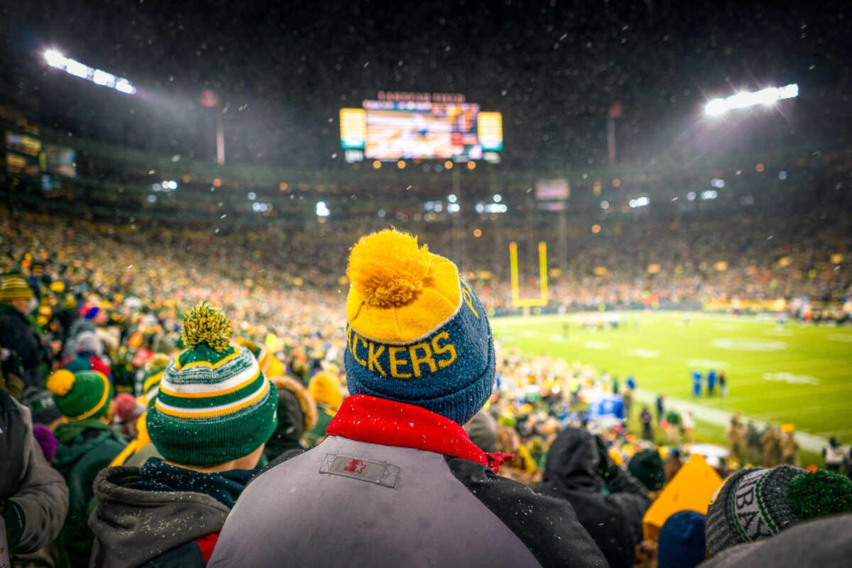 A fan wears a knit Packers hat at a snowy Lambeau Field as the Packers work to defeat the Carolina Panthers 24-16.