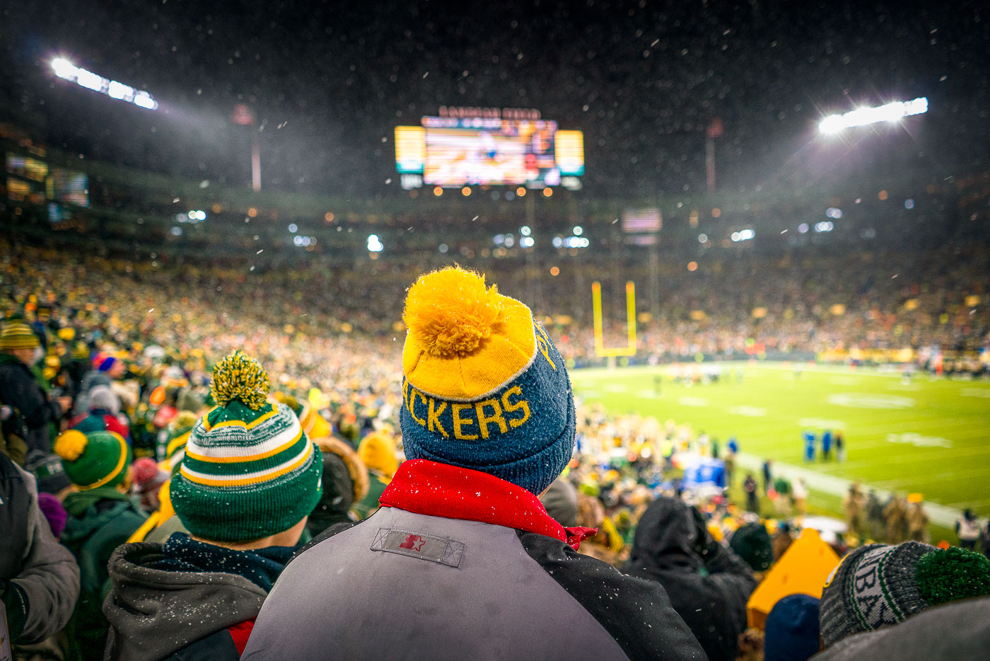 A fan wears a knit Packers hat at a snowy Lambeau Field as the Packers work to defeat the Carolina Panthers 24-16.