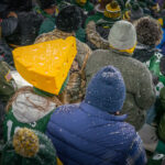 A fan at Lambeau Field wearing an Aaron Rodgers jersey with a cheesehead as the Green Bay Packers defeat the Carolina Panthers 24-16.
