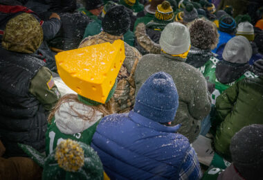 A fan at Lambeau Field wearing an Aaron Rodgers jersey with a cheesehead as the Green Bay Packers defeat the Carolina Panthers 24-16.