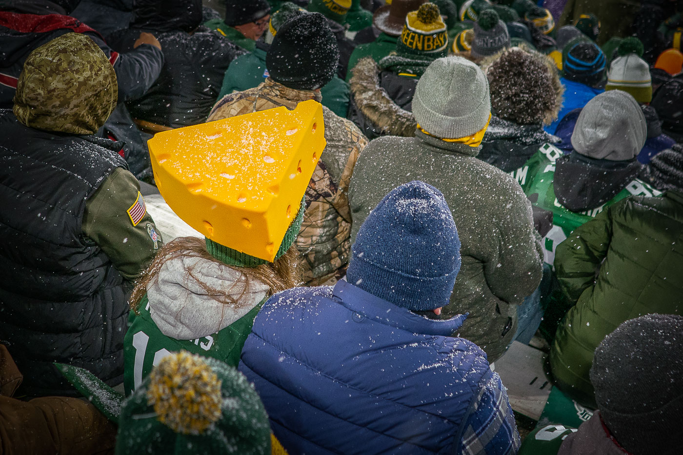 A fan at Lambeau Field wearing an Aaron Rodgers jersey with a cheesehead as the Green Bay Packers defeat the Carolina Panthers 24-16.
