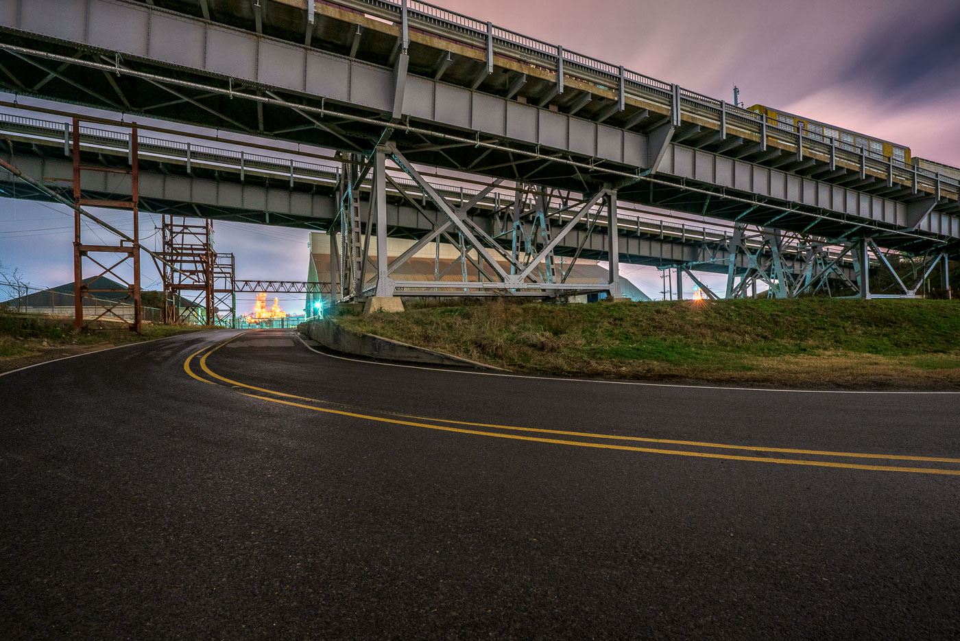 On Baton Rouge’s Airline Highway, the road snakes beneath a tangle of overpasses and steel supports, a striking symbol of mid-20th-century infrastructure. Originally developed as a major bypass route, Airline Highway became one of Louisiana’s busiest commercial arteries, linking petrochemical plants, warehouses, and neighborhoods across the capital region. At dusk, the glow of distant lights cuts through the industrial sprawl, underscoring how this corridor remains a vital — if gritty — backbone of the city’s economy and daily life.