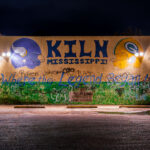 A mural painted on the wall of a gas station in Kiln Mississippi with all the helmets Brett Favre wore.