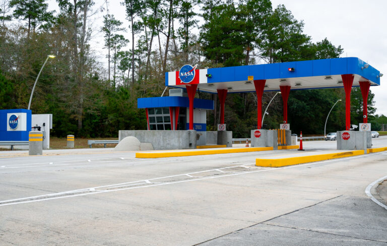 NASA Stennis Space Center Security Entrance 1 Nestled in the woods of Hancock County, Mississippi, the Stennis Space Center has been a cornerstone of NASA’s propulsion testing since the 1960s. The security gate, painted in the agency’s signature red, white, and blue, greets all who enter the sprawling complex where engines for Apollo, the Space Shuttle, and today’s Artemis missions have been put through their paces. The unassuming roadside checkpoint belies the scale of the technological achievements within, underscoring how a quiet patch of southern forest became central to America’s spaceflight history.