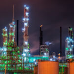 This nighttime industrial scene is from Baton Rouge, Louisiana, home to one of the largest oil refining and petrochemical hubs in the United States. The brightly lit towers and distillation columns belong to facilities along the Mississippi River Industrial Corridor, where refineries like ExxonMobil Baton Rouge operate around the clock. Steam and flares mark the ongoing refining processes that produce gasoline, diesel, and chemical feedstocks central to the region’s economy. The image captures the city’s long-standing connection to the energy and manufacturing industries.