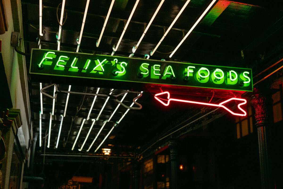 Felix's Sea Foods neon sign in New Orleans' French Quarter under awning lights