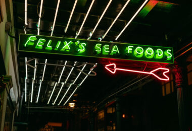 A neon sign glows above the entrance to Felix’s Sea Foods.  The restaurant is a well-known spot in New Orleans’ French Quarter, recognized for its oysters and casual seafood dining.