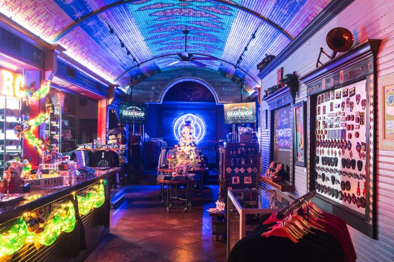 House of Blues Gear Shop, New Orleans 3 House of Blues Gear Shop interior with neon-lit display cases and colorful ceiling lighting.