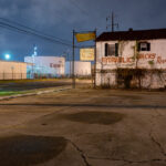 A former hydraulic jacks repair shop sits across from the massive ExxonMobile Oil Refinery in Baton Rouge, LA.