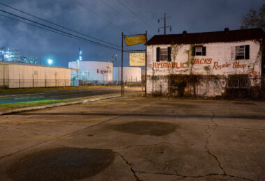 A former hydraulic jacks repair shop sits across from the massive ExxonMobile Oil Refinery in Baton Rouge, LA.